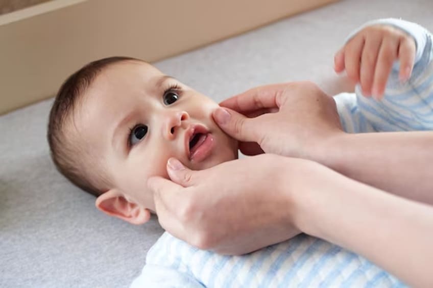 Pinching or Squeezing a Baby’s Cheeks and Face